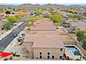 View of homes in a desert community with backyard pools and mountain views in the background at 2527 W Amber Sun Dr, Phoenix, AZ 85085
