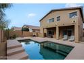 Backyard view featuring a rectangular pool with lounge chairs and covered patio space at 2527 W Amber Sun Dr, Phoenix, AZ 85085