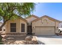 Charming home exterior features a two-car garage, manicured landscaping, and inviting curb appeal at 26826 N 66Th Ln, Phoenix, AZ 85083