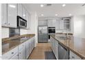 Modern kitchen with stainless steel appliances, granite countertops, neutral cabinets, tile floor, and stainless steel dishwasher at 3316 E Kingbird Pl, Chandler, AZ 85286