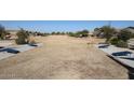 Expansive common area featuring cornhole boards and manicured landscaping offers recreational opportunities for residents at 34427 N Timberlake N Mnr, San Tan Valley, AZ 85144
