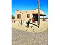 Desert home featuring native landscaping, including cacti and desert flora for low-maintenance beauty at 35524 N 215Th Dr, Wittmann, AZ 85361