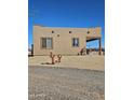 Southwestern-style home with desert landscaping, offering a unique and natural aesthetic at 35524 N 215Th Dr, Wittmann, AZ 85361