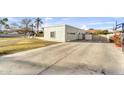 Detached two-car garage with a spacious driveway and basketball hoop, complemented by a well-kept lawn at 4010 E Grandview St, Mesa, AZ 85205