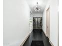 Long hallway with dark floors, white walls, a modern light fixture, and a wine display at 4219 N 41St Pl, Phoenix, AZ 85018