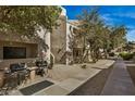 Exterior of building showing pedestrian walkway and shade trees at 4850 E Desert Cove Ave # 251, Scottsdale, AZ 85254