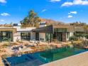 Modern exterior showing pool, spa and backyard, with mountain views in the distance at 4900 E Arroyo Verde Dr, Paradise Valley, AZ 85253