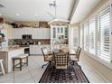 Kitchen with an adjacent eat-in breakfast nook area, white cabinets, stainless steel appliances and large windows at 5323 E Thunder Hawk E Rd, Cave Creek, AZ 85331