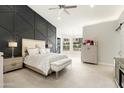Luxurious main bedroom with a decorative accent wall, carpet flooring, and a seating area at 5456 E Woodridge Dr, Scottsdale, AZ 85254