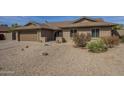 Inviting single-story home featuring a two car garage and desert landscaping at 6010 E Greenway Ln, Scottsdale, AZ 85254