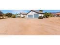 Attractive single-story home featuring desert landscaping and a three-car garage at 6404 S Lazy Ln, Gold Canyon, AZ 85118