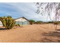 Expansive property featuring desert landscaping, a three-car garage and beautiful mountain views at 6404 S Lazy Ln, Gold Canyon, AZ 85118