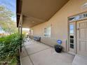 Covered front patio featuring a comfortable bench and security system near the entrance at 757 W Magma Rd, San Tan Valley, AZ 85143