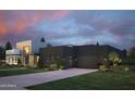 Sleek modern architecture with a dark color scheme, complemented by a well-maintained green lawn at 86Xx E Stagecoach Pass # 4, Carefree, AZ 85377