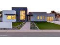 Modern home with a well-manicured lawn, desert landscaping, and a stylish glass garage door at 86Xx E Stagecoach Pass # 4, Carefree, AZ 85377