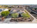 Expansive aerial view of the single-Gathering home featuring a red tile roof, desert landscaping, and block wall enclosed backyard at 9183 W Foothill Dr, Peoria, AZ 85383
