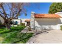 Well-maintained home with red tile roof, two-car garage, and desert landscaping at 9210 E Altadena Ave, Scottsdale, AZ 85260