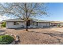 Charming single-story home with a well-kept yard and neutral color palette at 11265 E Laguna Azul Cir, Mesa, AZ 85209