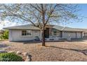 Inviting home with natural stone accents and mature landscaping at 11265 E Laguna Azul Cir, Mesa, AZ 85209