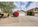 Charming single-Gathering home with a well-maintained lawn, desert landscaping, and a two-car garage at 12622 W Avalon Dr, Avondale, AZ 85392