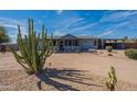 Beautiful single-story home with desert landscaping and large cactus in the front yard at 1612 N 201St Ave, Buckeye, AZ 85396