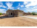 Single-story home with neutral stucco, tile roof, and desert landscaping under a cloudy sky at 16629 E Westby Dr, Fountain Hills, AZ 85268