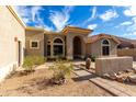 Charming single-story home featuring a desert landscape, arched entryway and tile roof at 16629 E Westby Dr, Fountain Hills, AZ 85268