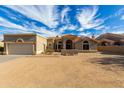 Single story home with a red tile roof and desert landscaping under a cloudy blue sky at 16629 E Westby Dr, Fountain Hills, AZ 85268