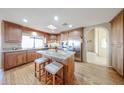 Lovely kitchen featuring wood cabinets, a center island with seating, and stainless steel appliances at 17104 E Rand Dr, Fountain Hills, AZ 85268