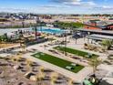 Aerial view of the community amenities featuring bocce ball court, playground, and a splash pad at 17729 W Amber Dr, Goodyear, AZ 85338