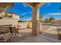 Inviting front porch with seating area and a view of the desert street at 19802 N Greenview Dr, Sun City West, AZ 85375