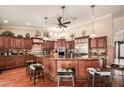 Gourmet kitchen with stainless steel appliances, granite countertops, and custom wood cabinetry at 24413 S Lakeway Sw Cir, Sun Lakes, AZ 85248