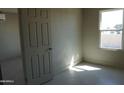 Bright bedroom with tile flooring, fresh paint, and a large window for natural light at 246 E Central Ave, Coolidge, AZ 85128