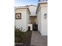 The inviting entryway to this single-Gathering home features desert landscaping and classic architectural details at 2777 W Queen Creek Rd # 13, Chandler, AZ 85248