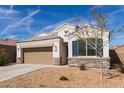 Inviting single-story home with a tidy front yard featuring desert landscaping and a spacious two-car garage at 30940 W Indianola Ave, Buckeye, AZ 85396