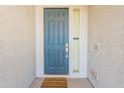 Welcoming front door with a side window and security features at 34074 N Beeblossom Trl, San Tan Valley, AZ 85144