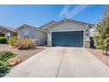 Inviting single-story home with a well-manicured desert front yard at 34074 N Beeblossom Trl, San Tan Valley, AZ 85144