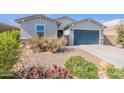 Attractive one-story home with a desert landscape and a two-car garage at 34074 N Beeblossom Trl, San Tan Valley, AZ 85144