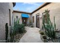 Private courtyard featuring beautiful desert landscape and stone pathway to the front door at 35322 N 27Th Ln, Phoenix, AZ 85086