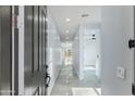 Bright and modern entryway with gray walls and glossy tiled floors leading into the home at 3623 S 78Th Dr, Phoenix, AZ 85043