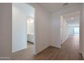 Bright hallway with wood-look tile flooring and views of the bathroom and the living room at 4083 W Eli Dr, San Tan Valley, AZ 85144