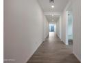 Long hallway with tile flooring, white walls, and recessed lighting leading to the backyard at 4093 W Eli Dr, San Tan Valley, AZ 85144