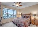 Cozy bedroom with a large window overlooking the landscaped backyard at 41012 N Noble Hawk Way, Anthem, AZ 85086