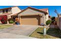 Charming single-Gathering home featuring a two-car garage, beautiful landscaping, and a classic desert tile roof at 4226 E Jojoba Rd, Phoenix, AZ 85044