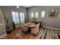 Bright dining room featuring a round wood table, neutral chairs and plantation shutters at 4312 W Olney Ave, Laveen, AZ 85339