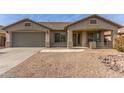 Inviting single-story home with desert landscaping, covered entry, and attached two-car garage at 43554 W Sunland Dr, Maricopa, AZ 85138