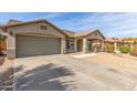 Attractive single-level house with a two-car garage, gravel yard, and covered front porch at 43554 W Sunland Dr, Maricopa, AZ 85138