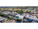 An aerial perspective showcases a home's backyard oasis, complete with a pristine pool, patio area, and mature trees at 5401 N 81St Pl, Scottsdale, AZ 85250