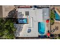 An aerial photograph displays a home's expansive backyard, complete with a sparkling pool, covered patio, and mature landscaping at 5401 N 81St Pl, Scottsdale, AZ 85250