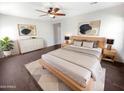 Comfortable main bedroom featuring a ceiling fan, neutral decor, and ample natural light at 5822 W Huntington Dr, Laveen, AZ 85339